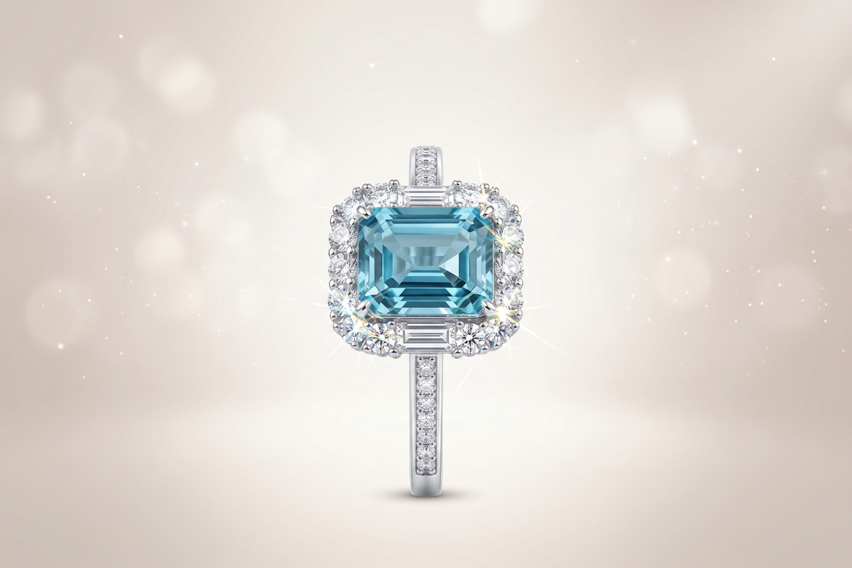 Bague ornée d'une pierre précieuse taille émeraude avec double halo et anneau pavé