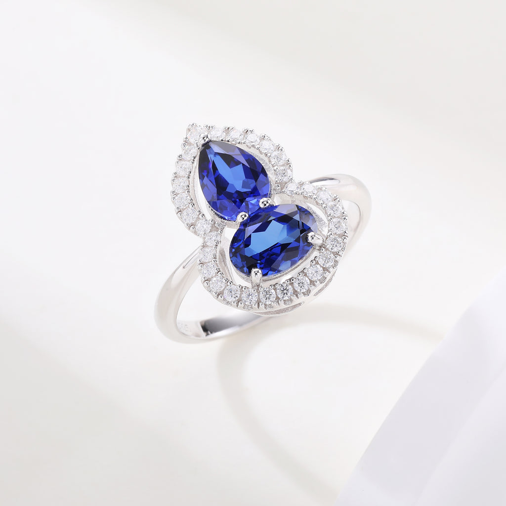 Bague sertie de pierres en forme de gourde avec halo complet